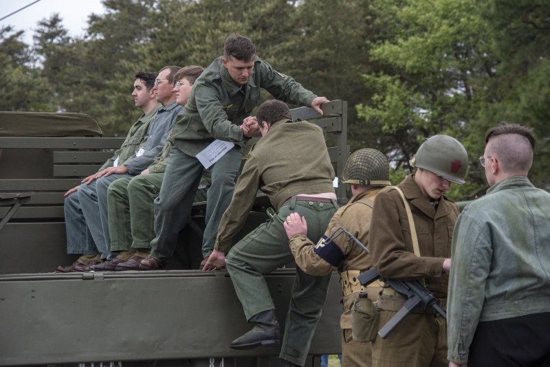 German submarine soldiers are processed and loaded on a truck for transport to prison.
